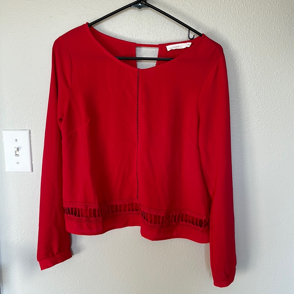 Women’s pink cropped blouse with front and back cutout details. Size S